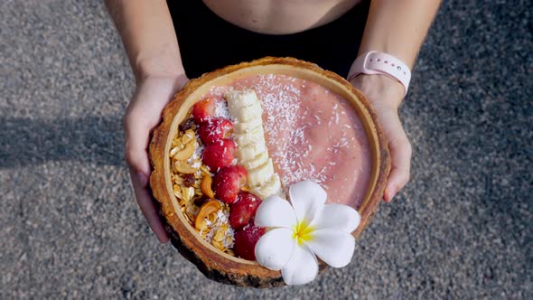 Sport Woman Holding Breakfast Acai Bowl with Vegan Raw Food