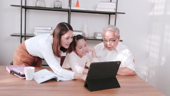 Grandfather and daughter helping children during virtual classes. Concept of new normal.