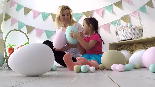 Pretty Little Girl Giving Decorated Eggs and Greeting Cards to Mother and Grandmother at Easter