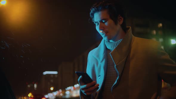 Young Stylish Man Smoking Cigarette and Texting a Message