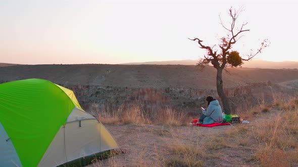 Woman Taking Landscape Photo While Camping
