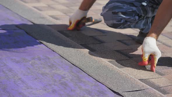 Roofing Work. Laying a Soft Roof on the Roof of a Private House.