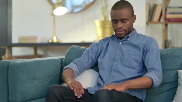 Young African Man Closing Laptop Going Away From Sofa