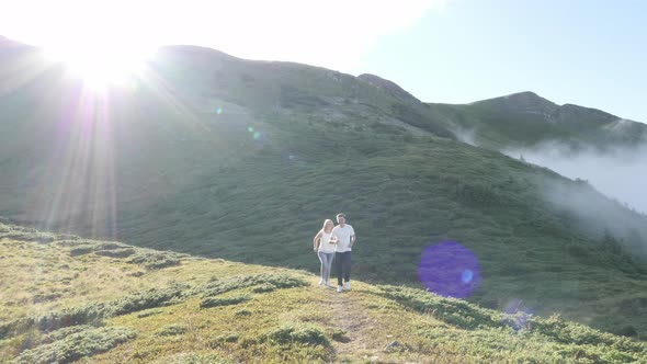 Couple running on a hill