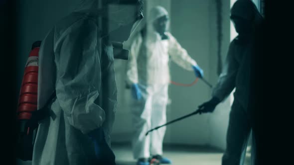 Men Clean Room with Disinfectants During Coronavirus Pandemic.