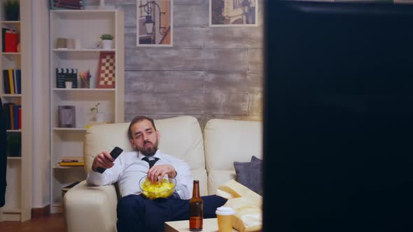 Tired and Bored Businessman with Tie Relaxing Watching Tv