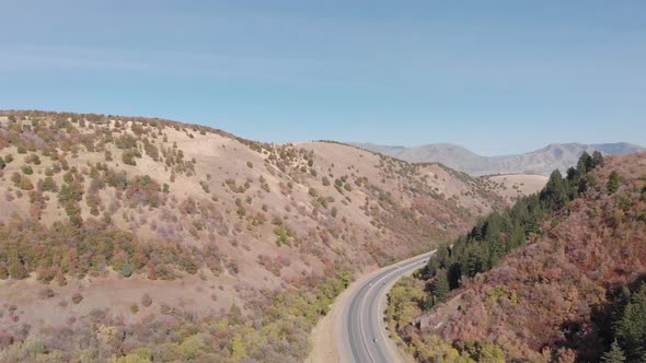 Winding Road Through Utah Canyon in Autumn with Blue Sky Aerial Drone 4K