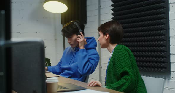 A Young Man and Woman Working on a Common Project and Using Laptops