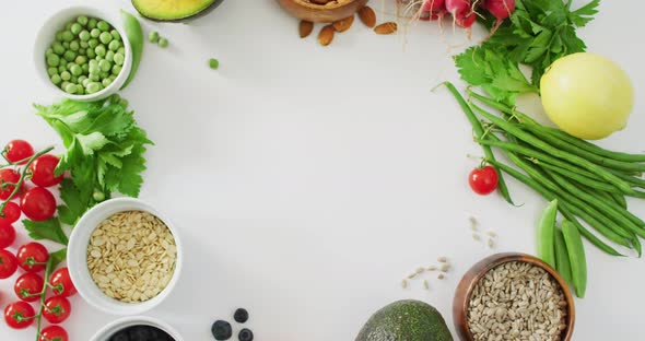 Video of fresh vegetables, seeds and berries with copy space on white background