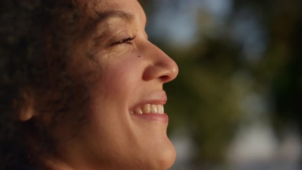 Happy African American Woman Enjoying Warm Golden Sunlight Outdoors Portrait