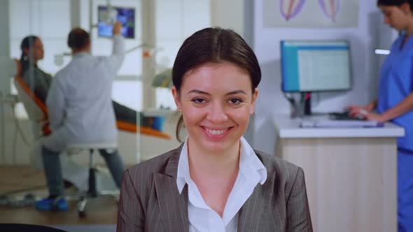 Portrait of Smiling Young Patient Looking on Webcam Sitting on Chair