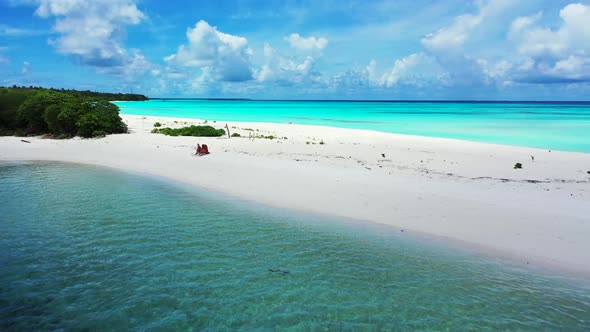 Ladies sunbathing on paradise shore beach voyage by blue water and white sandy background of the Mal