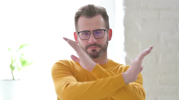 Portrait of Man Showing No Sign Arms Crossed