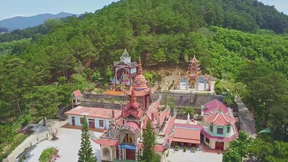 Flycam Rises High Above Countryside with Temple Town Village