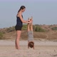 Young Sporty Mother with Little Daughter Doing Gymnastic on the Beach - VideoHive Item for Sale