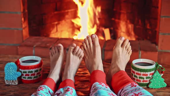 Mother and Child near Fireplace. People Relaxing at Home