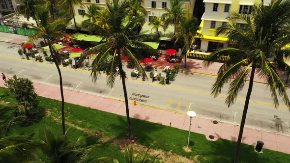 Aerial overhead shot of hotels in Miami Beach tables spread out to the road social distancing