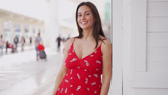 Cheerful Latin American Woman in Trendy Dress Standing on Street