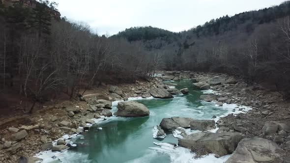 Drone Following Icy River