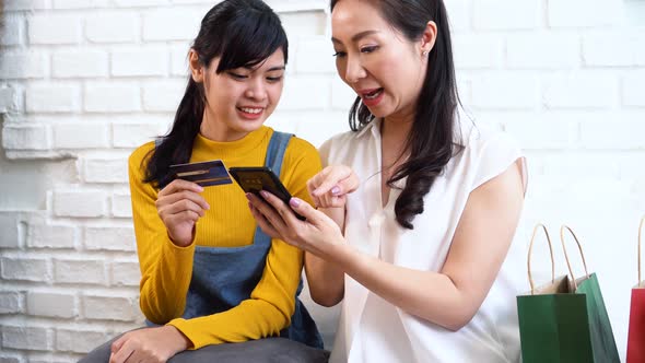 Cheerful Asian Women Shopping Online Using Smartphone