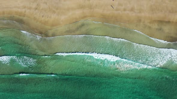 Vertical view on the Norwegian sand beach and sea waves