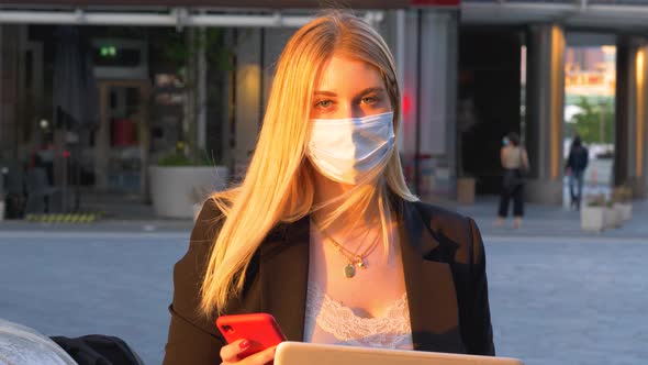 Slow motion shot of businesswoman wearing protective mask