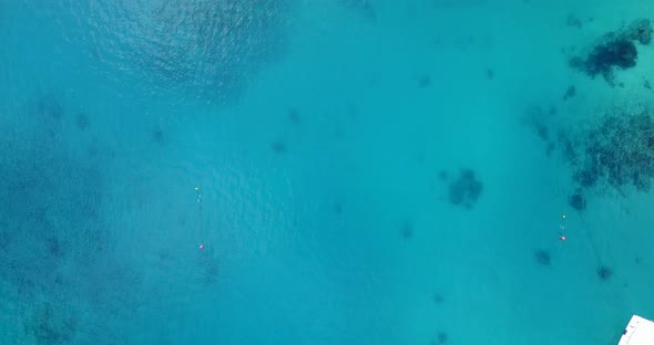 Daytime aerial abstract shot of a white sandy paradise beach and aqua turquoise water background in 