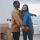 Young couple hug each other in their new home - VideoHive Item for Sale