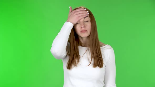 Portrait of Pretty Young Woman Is Upset and Making Facepalm.