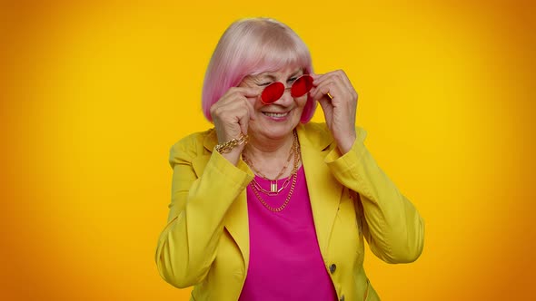 Happy Playful Elderly Granny Woman in Red Sunglasses Blinking Eye Looking at Camera with Smile