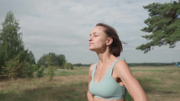 Medium Parallax Shot of Blond Caucasian Woman Jogger in Forest in Sunny Day