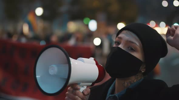 Demonstrations Against Covid-19 Lockdown Measures. Young Woman with Face Mask Shouting Into the