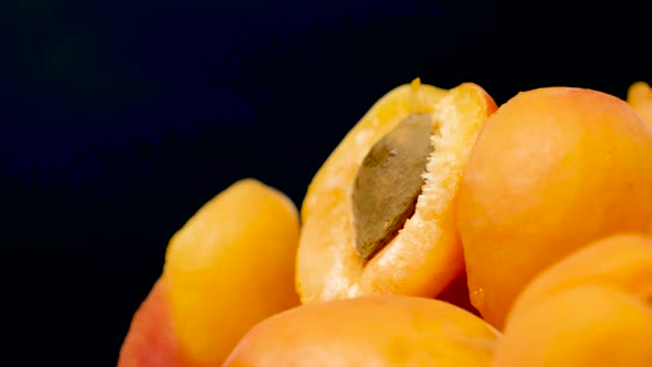 A Lot of Ripe Juicy Apricots in Motion Spin in a Circle Peeled Apricots with Pits