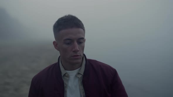 Depressed Man Looking Ocean Horizon in Morning Mist