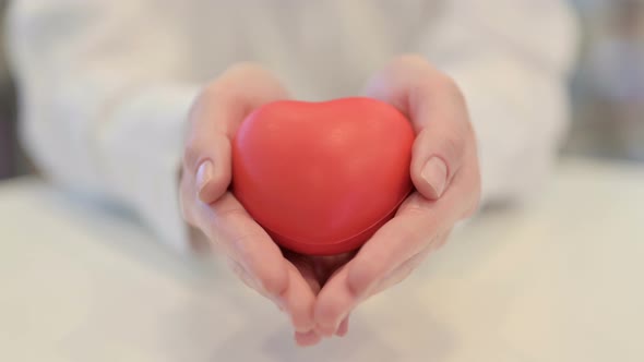 Female Hands Holding Heart Shaped Object Close Up