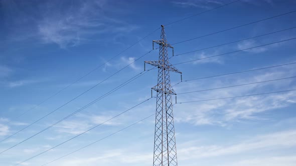 High voltage power lines and electricity pylon on sky background, Time lapse