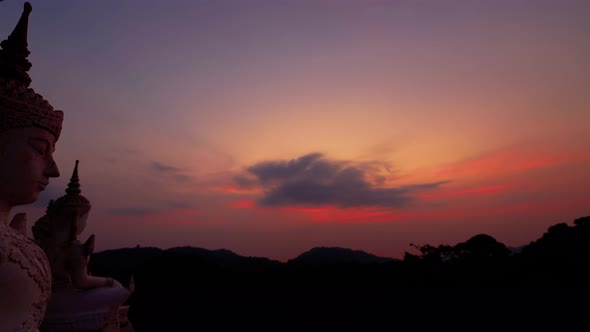 Colorful cloudy Sunset time lapse, mountain view with Thai Buddha statues, Samui Thailand