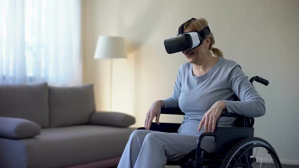 Retired Woman in Wheelchair Wearing Vr Goggles and Enjoying Game, Technology