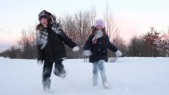 Happy Kids Girls Running in the Snow on a Winter Day Winter Holidays Games Concept
