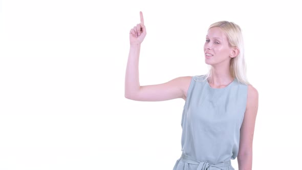 Happy Young Blonde Woman Thinking and Pointing Up