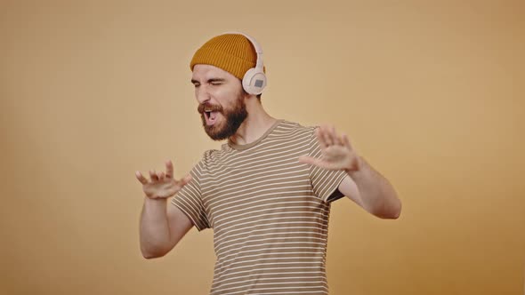 Mature Hipster Likes Listening to Music in Studio Closeup