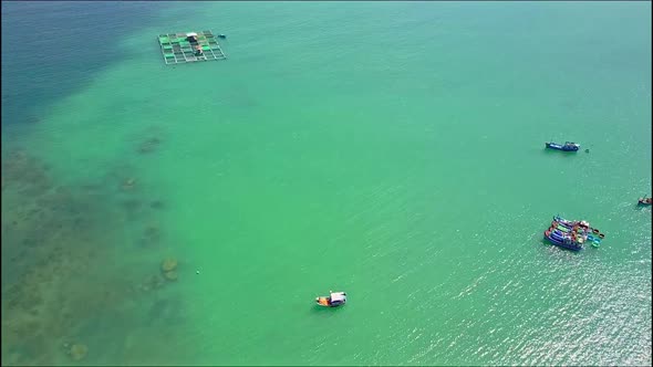 Drone Flies Over Fishing Boats on Azure Sea Surface