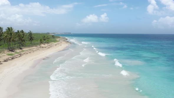 Aerial Footage of the Wide Shore with Thick White Sands and Turquoise Waves