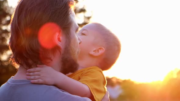 Father and Son Playing Outdoors at the Sunset Time