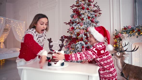 Mother and Son are Sitting Near the Christmas Cake