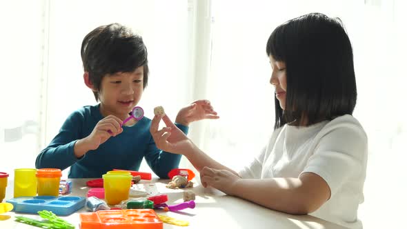 Asian Children Have A Fun Together With Colorful Modeling Clay At Home