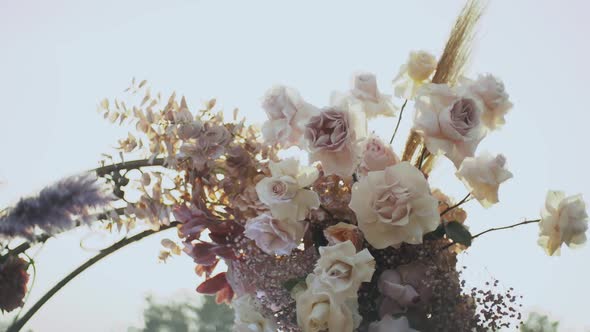 Close Up View of Wedding Floral Decorations Arch of Flowers in Pastel Faded Colors Slow Motion