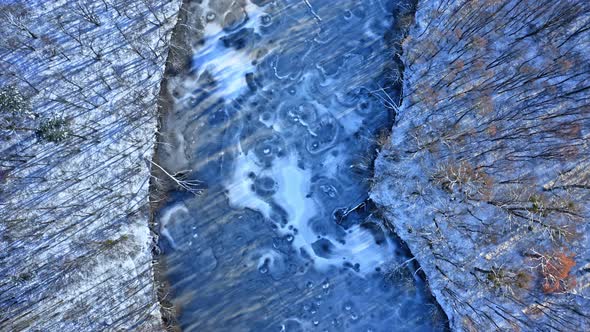 Winter cold river and forest. Aerial view of wildlife, Poland