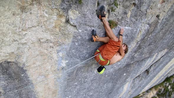 A man rock climbing up a mountain.
