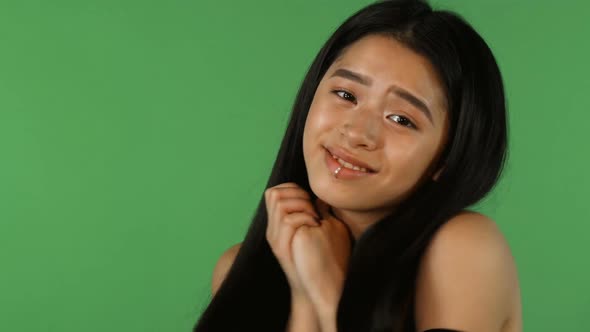 Stunning Beautiful Asian Woman Looking Cute and Happy on Green Backgorund 1080p